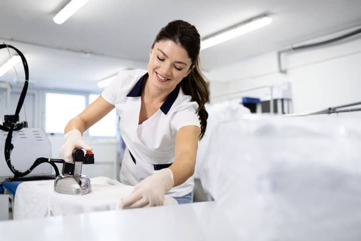 Worker Ironing Clothes